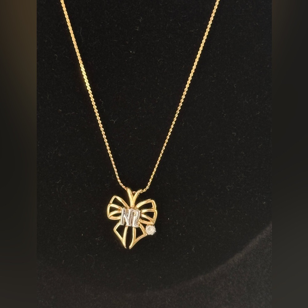 Vintage Nina Ricci NR Bow Pendant Necklace Gold Tone Crystal Accent